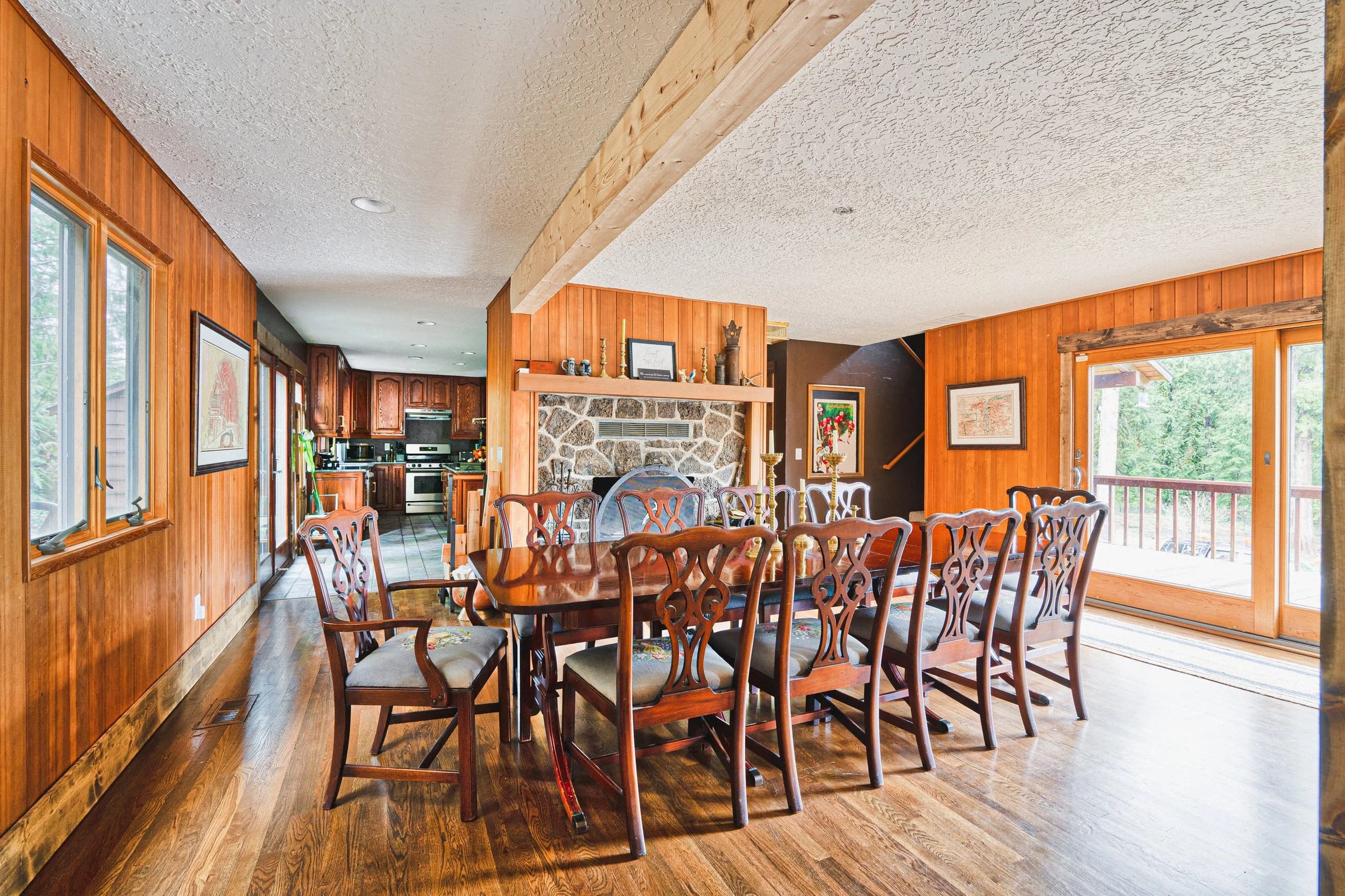 The Lodge dining room, a long table and chairs beside the stone fireplace